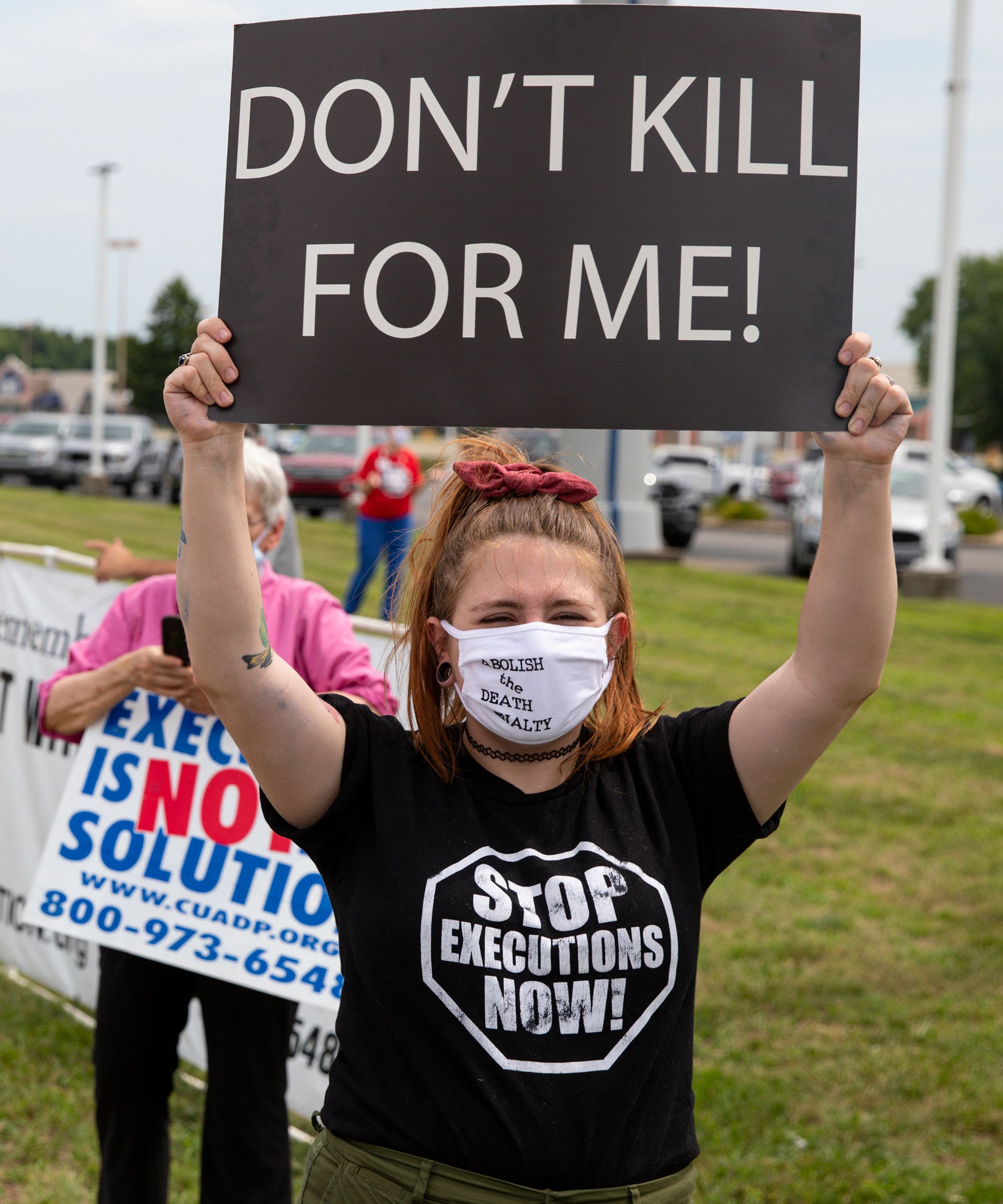 Woman Wearing A Black Shirt Holding Don't Kill For Me Sign