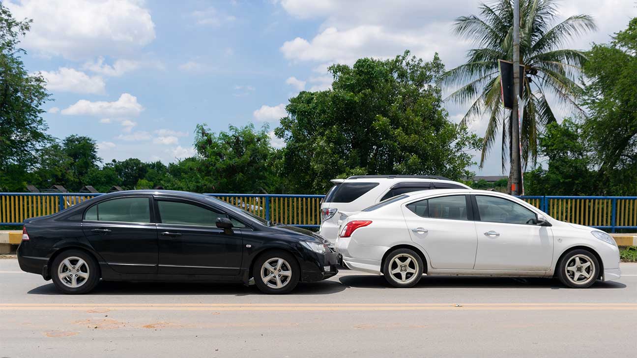 An accident between a black car and a white car