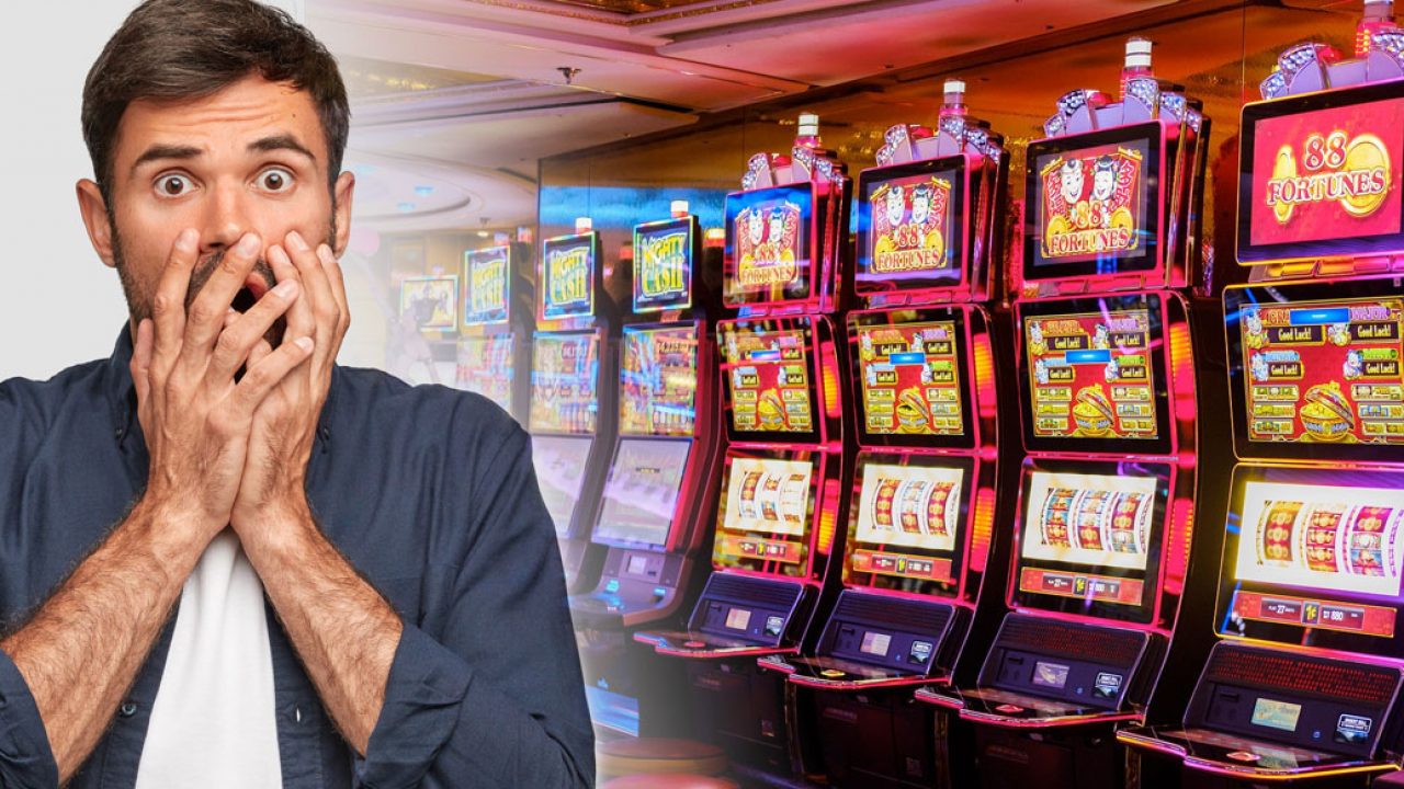 A man in a shocking expression on the background of slot machines