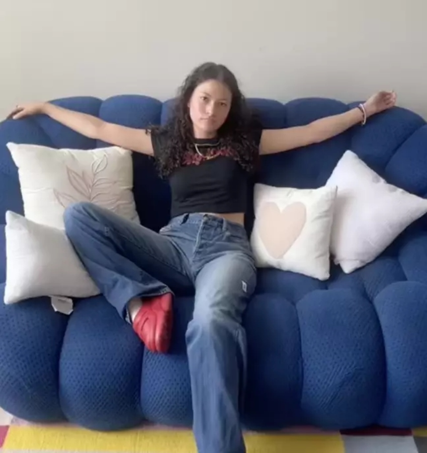Amanda Joy sitting on her Bubble’ couch from French brand Roche Bobois