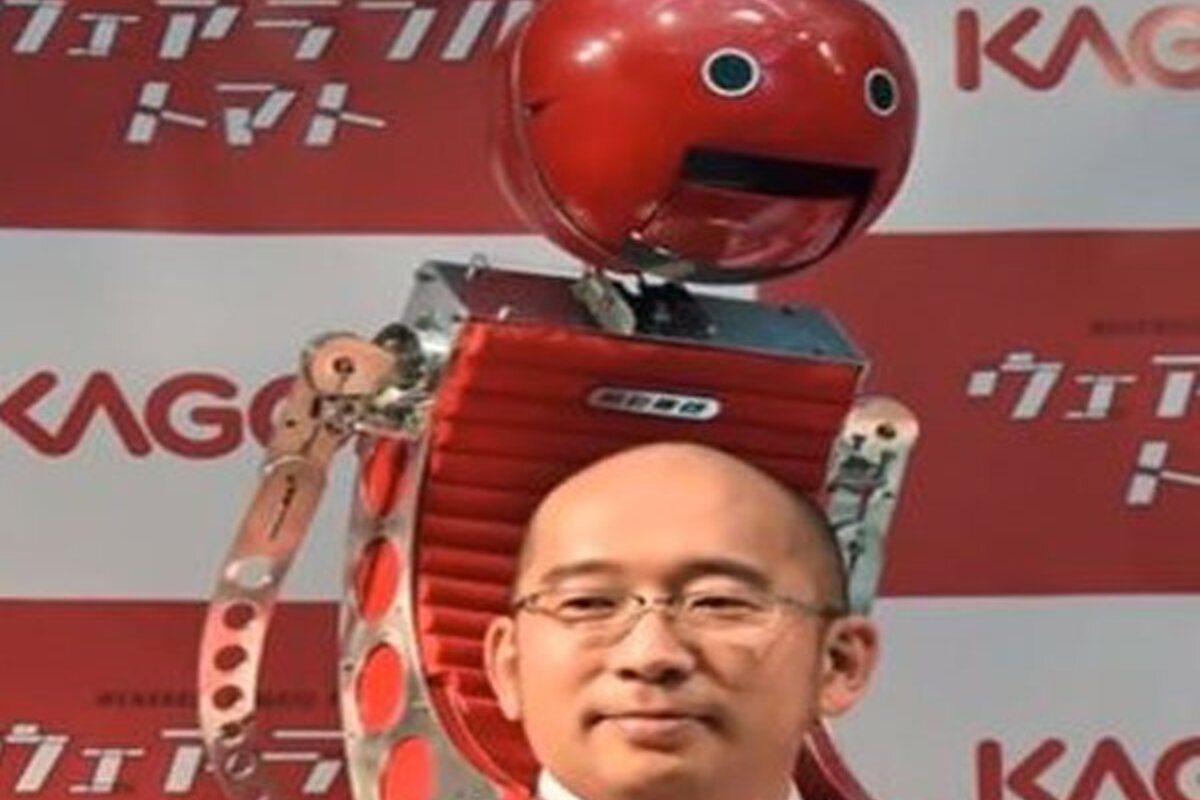 A Japanese man wearing tomato robot at the premiere launch of tomatan