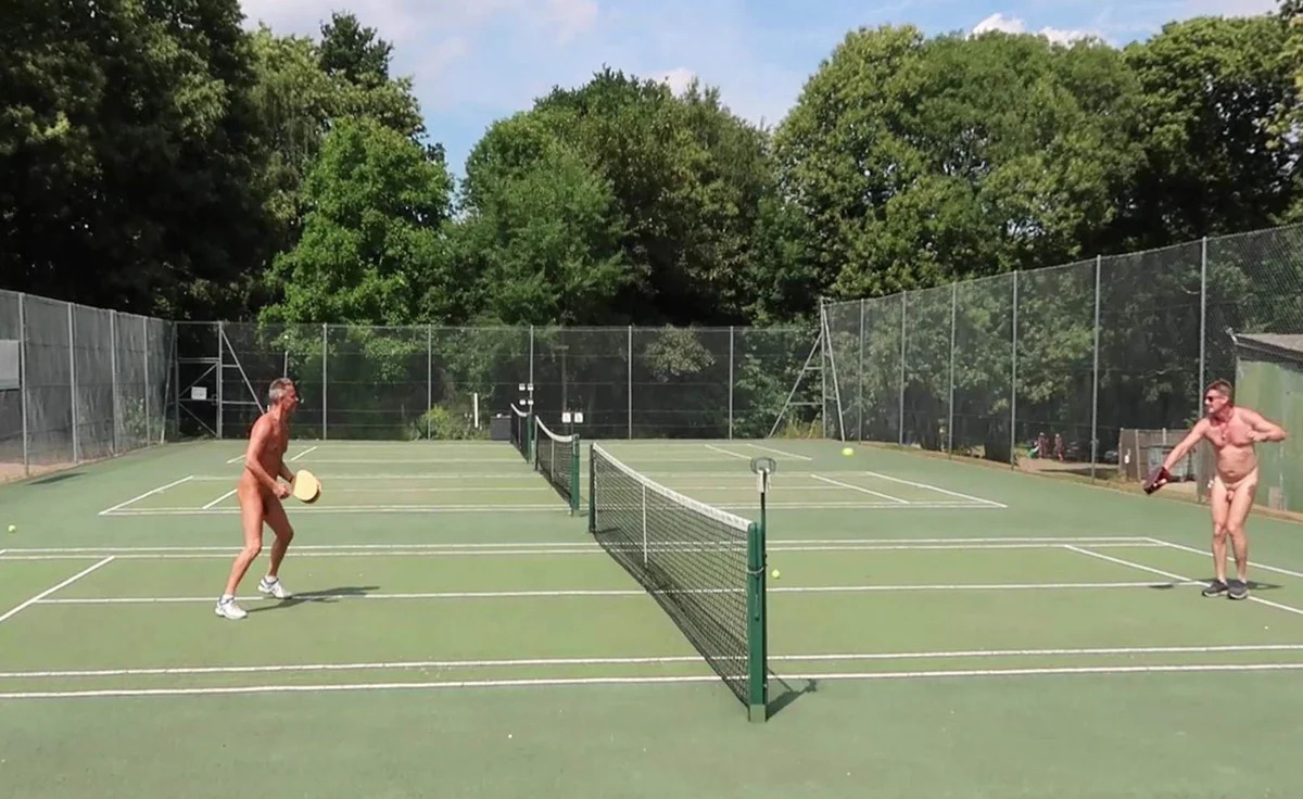 Men playing tennis naked at the Diogenes Sun Club in Buckinghamshire