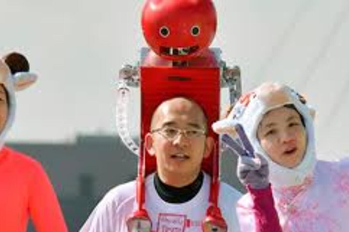A Japanese man wearing tomatan with a Japanese girl standing with him making a victory sign