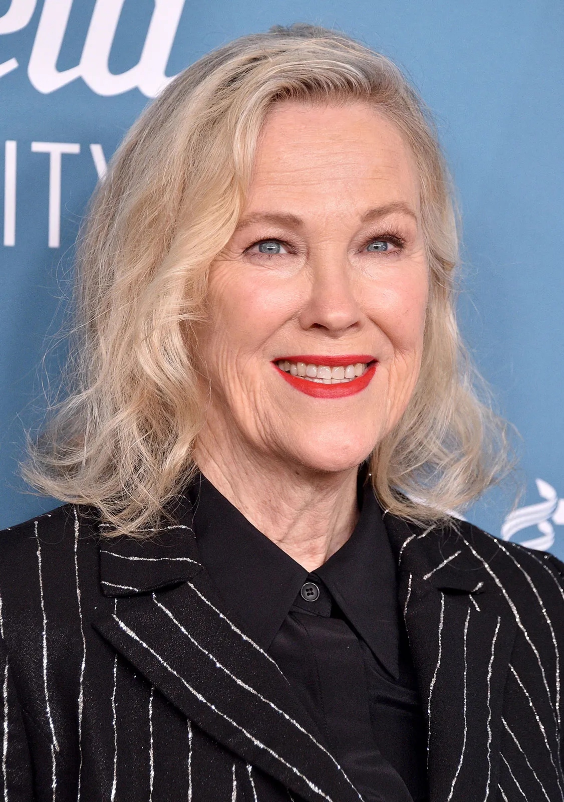 Catherine O'Hara wearing a black outfit