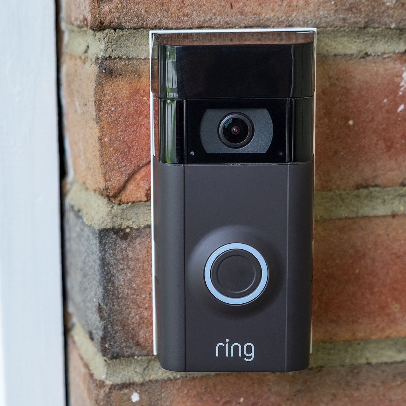 Black ring camera on a brick wall
