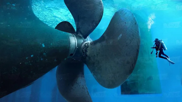 A diver and a huge ship propeller.