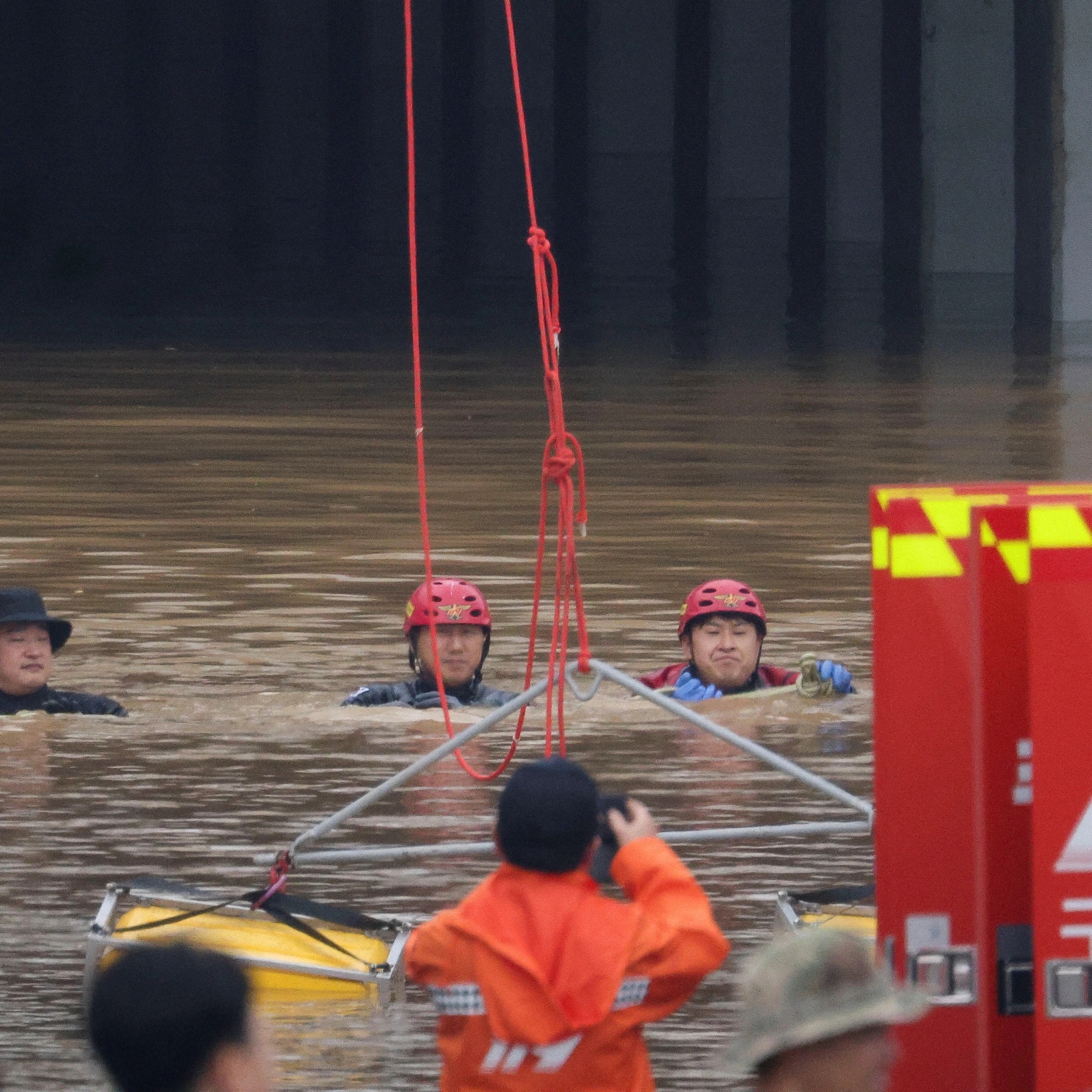 Rescuers searching for people after heavy floods trapped vehicle in the tunnel.