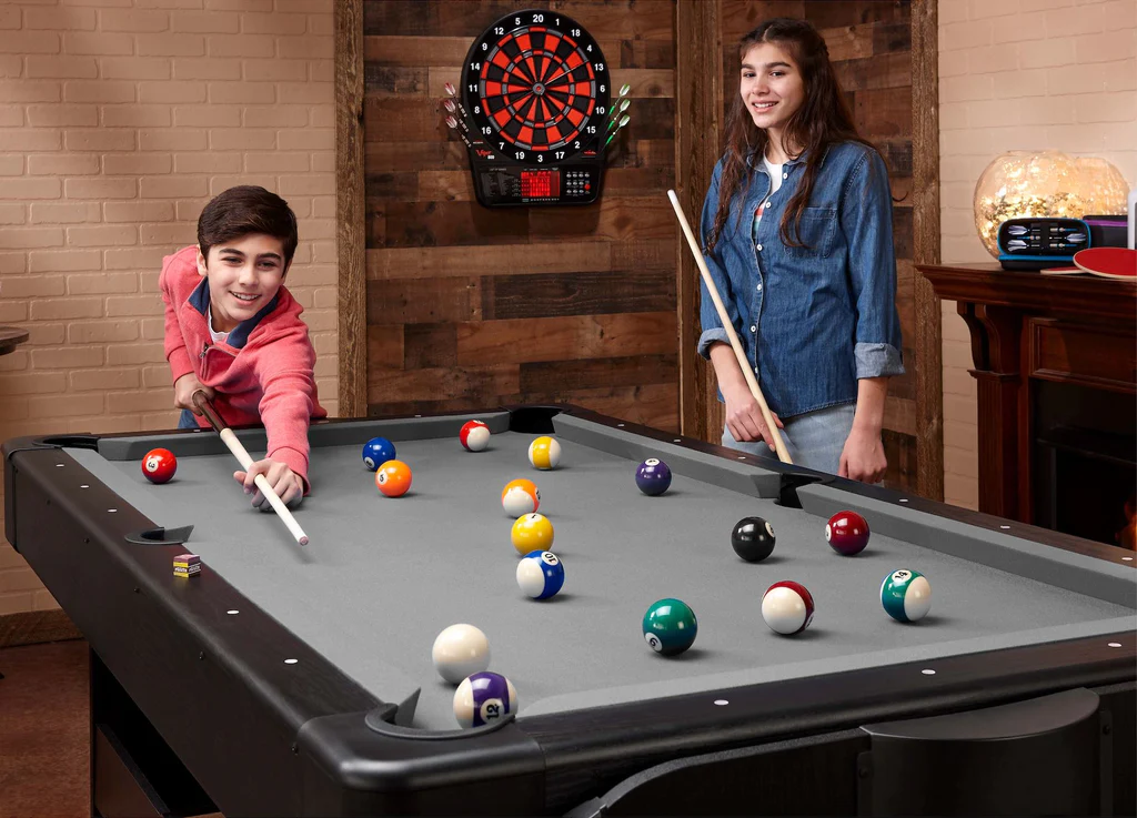 A girl and boy are playing billiard game.