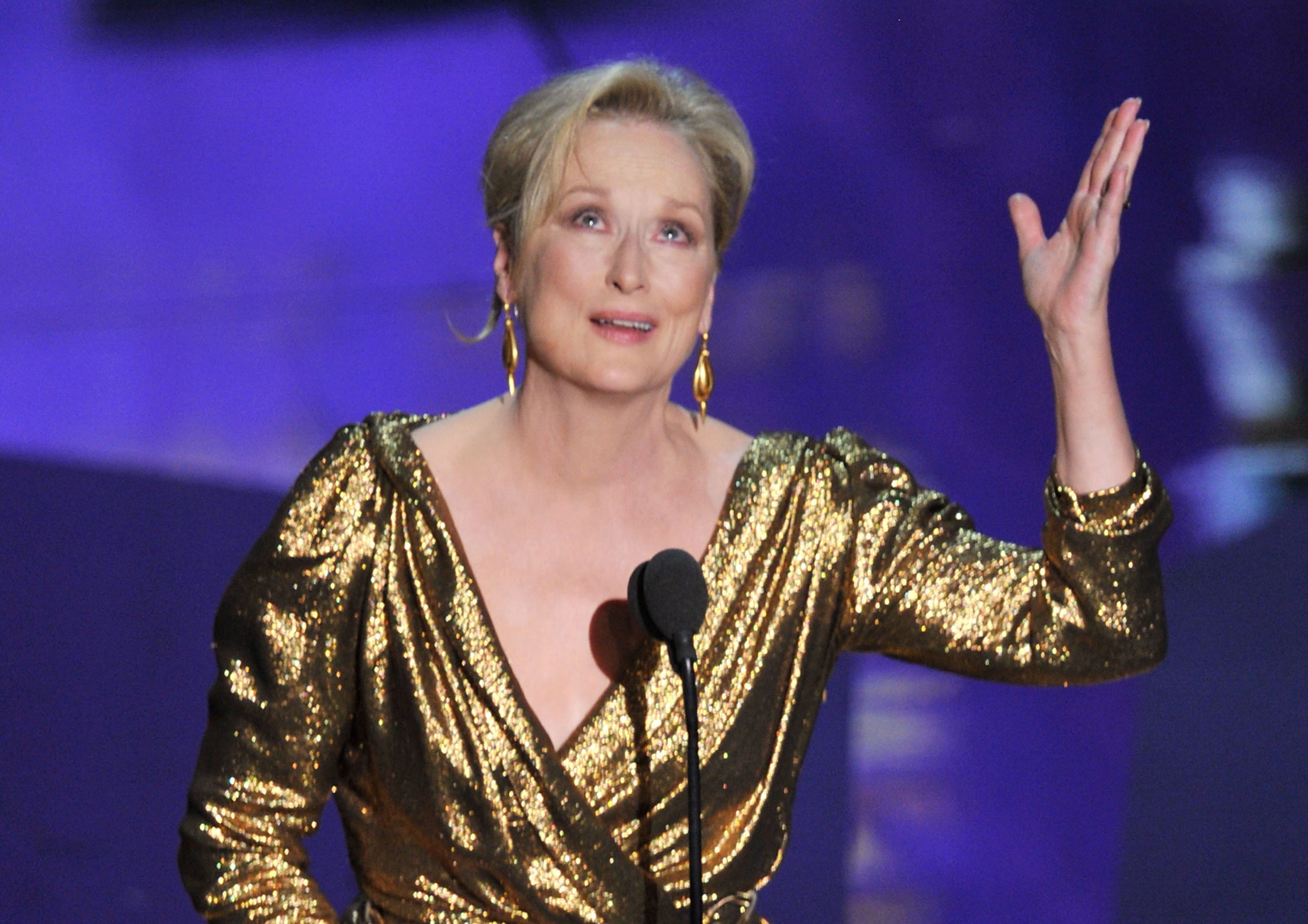 Meryl Streep wearing a gold dress
