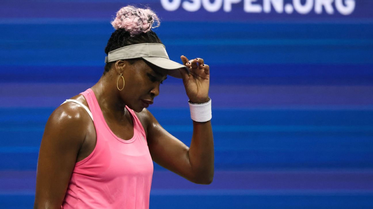 Venus Williams wearing a pink drerss and white tennis cap
