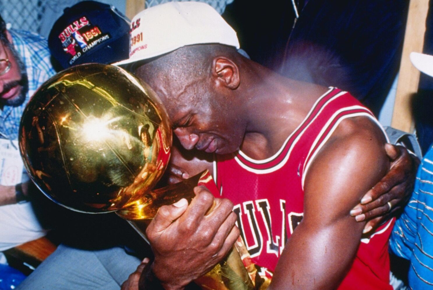 Michael Jordan holding a trophy while crying