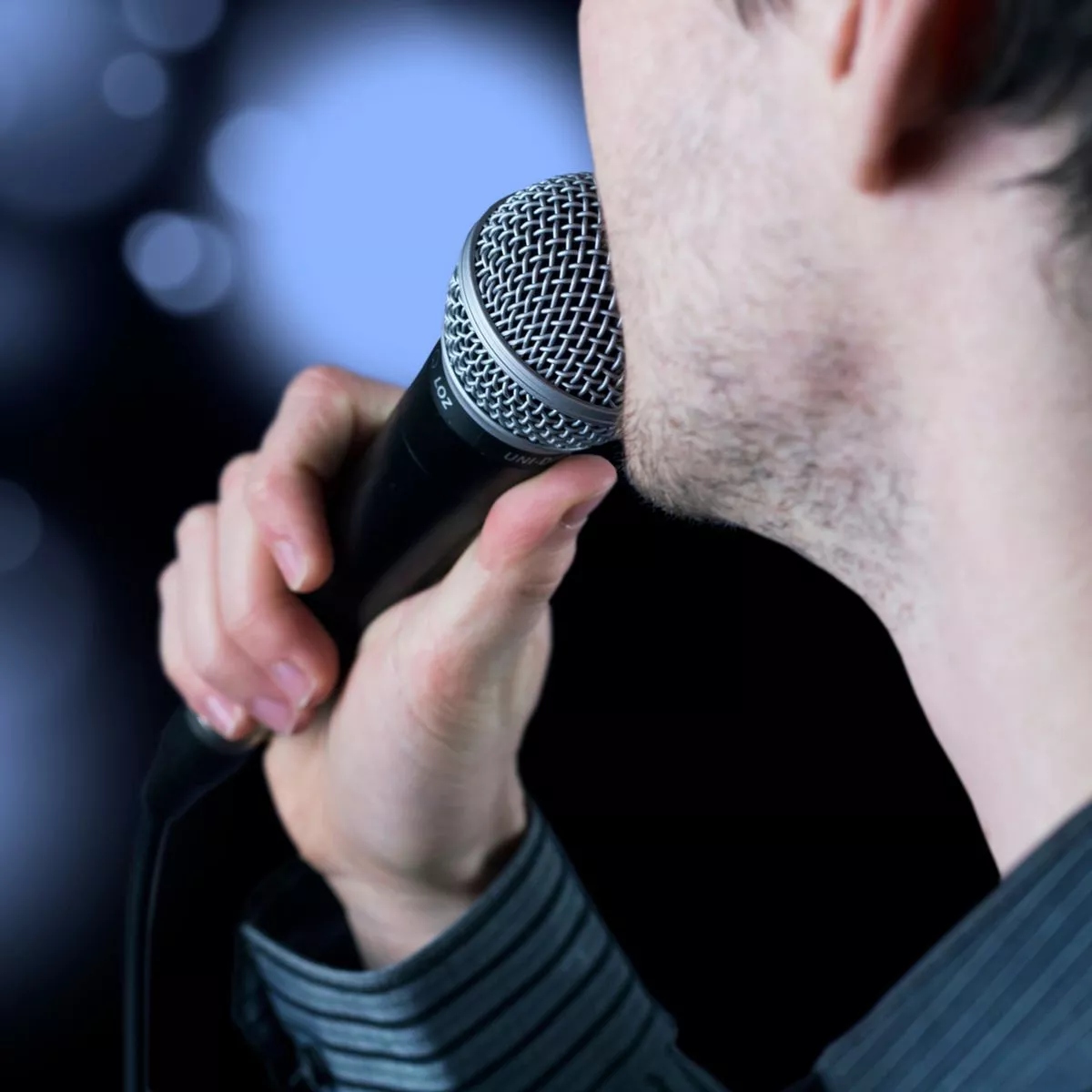 A man singing on a microphone