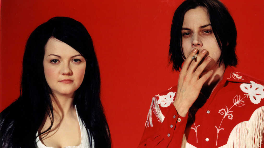 The two members of The White Stripes rock band with the male smoking