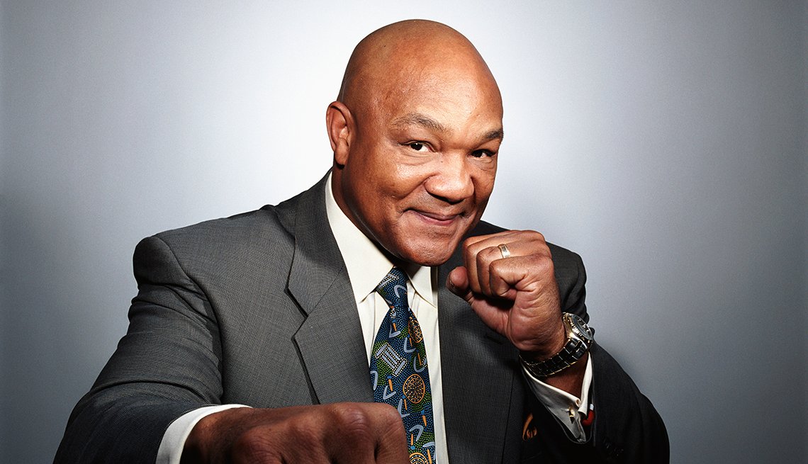 George Foreman wearing a light gray suit
