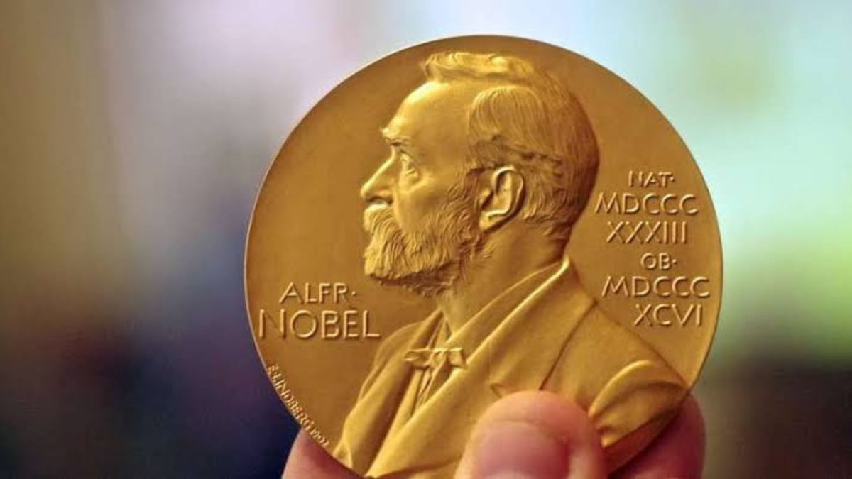 Hand holding a Nobel Prize