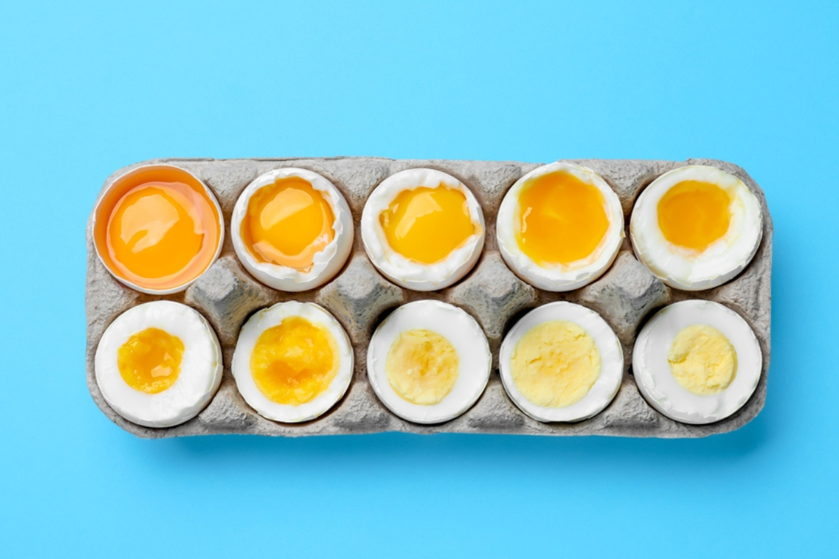 Different levels of cooked boiled eggs on an egg carton