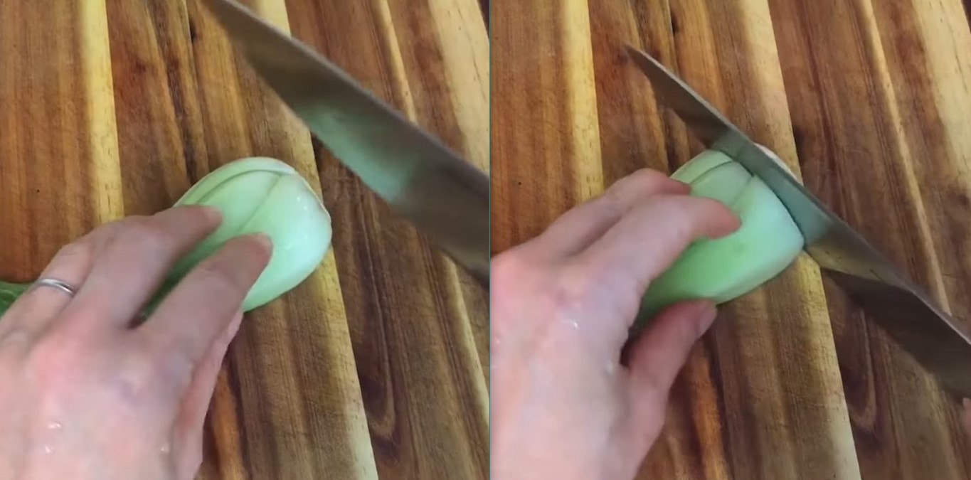 A knife about to cut the base of a bok choy; a knife slicing the base of a bok choy