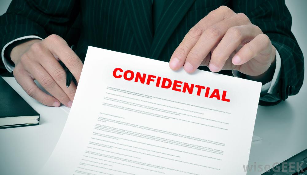 A man holding a piece of paper that says Confidential