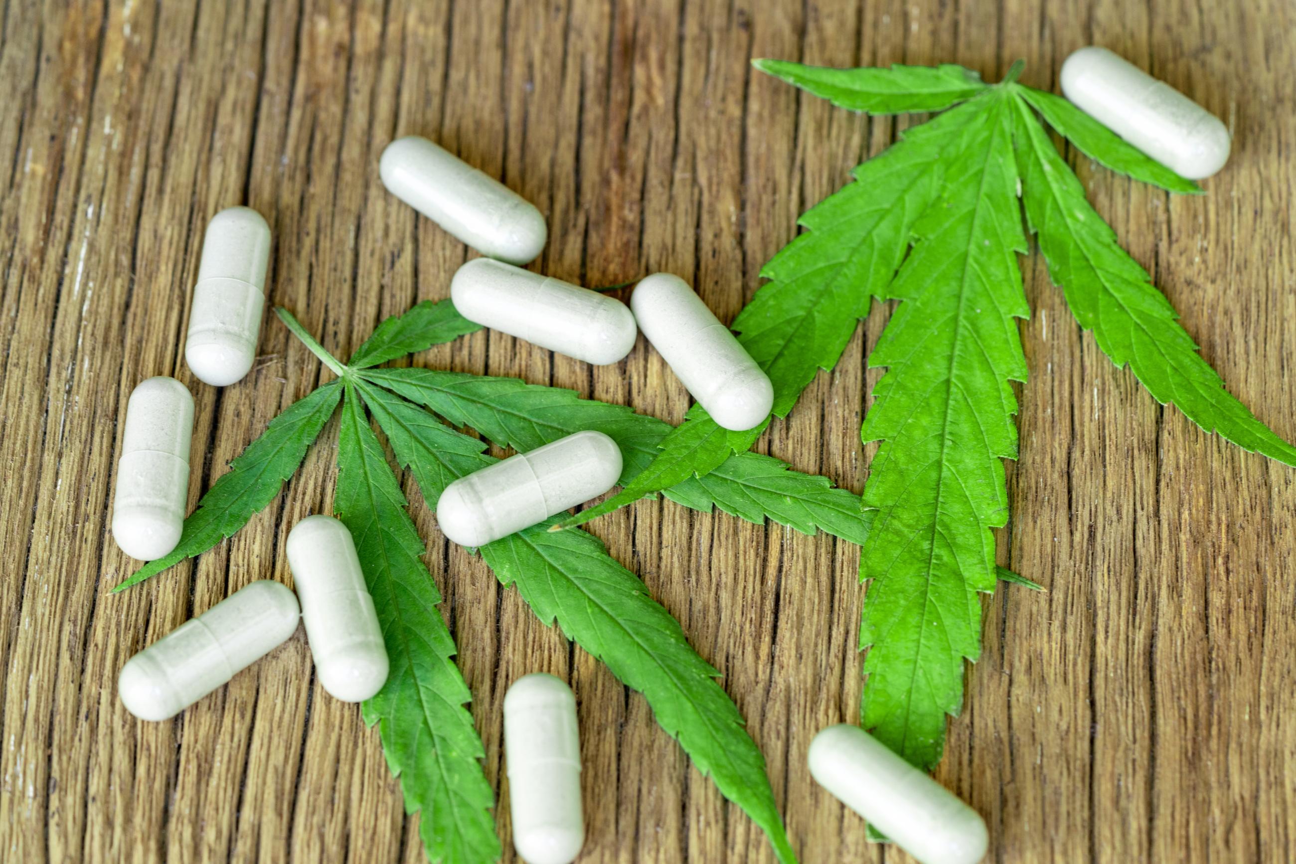 Cannabis leaves and white capsules