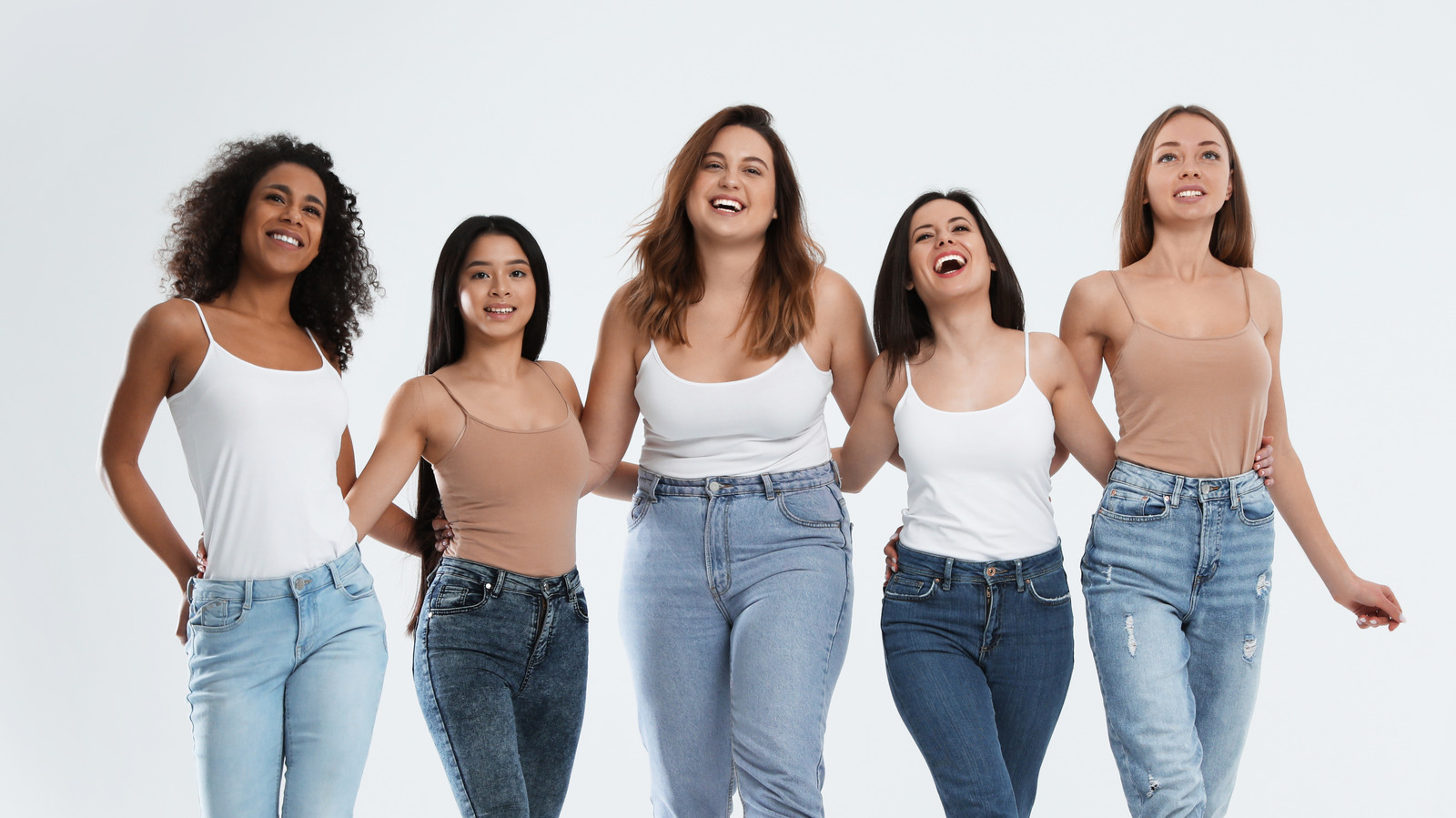 Five women are standing with their arms around the waists of each other.