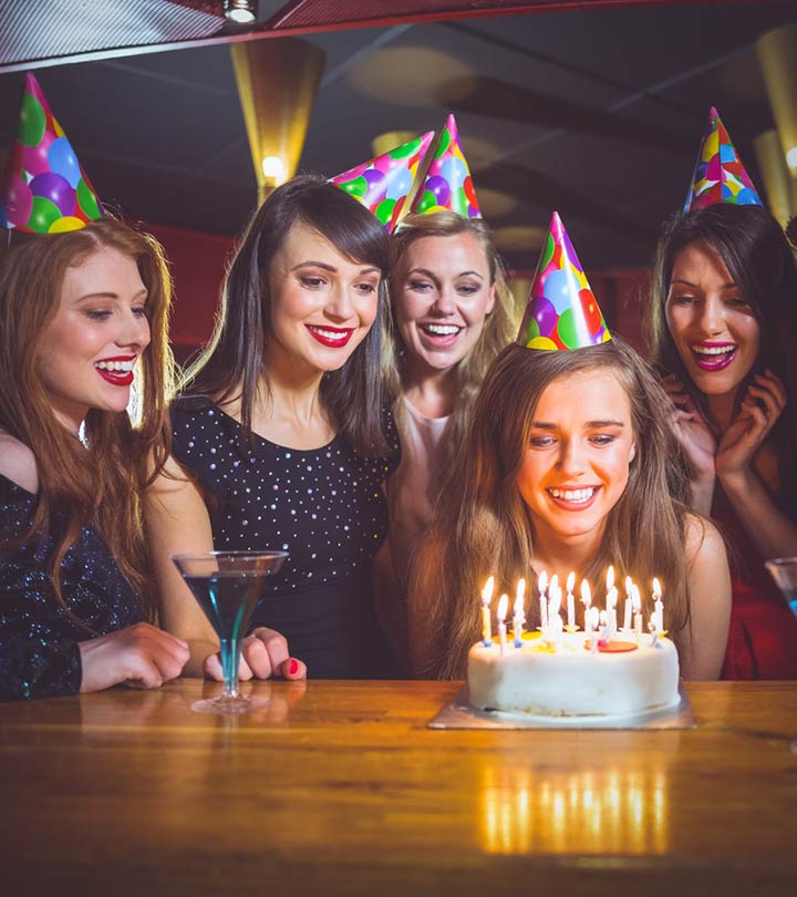 Group of female friends celebrating their friend's birthday with a party