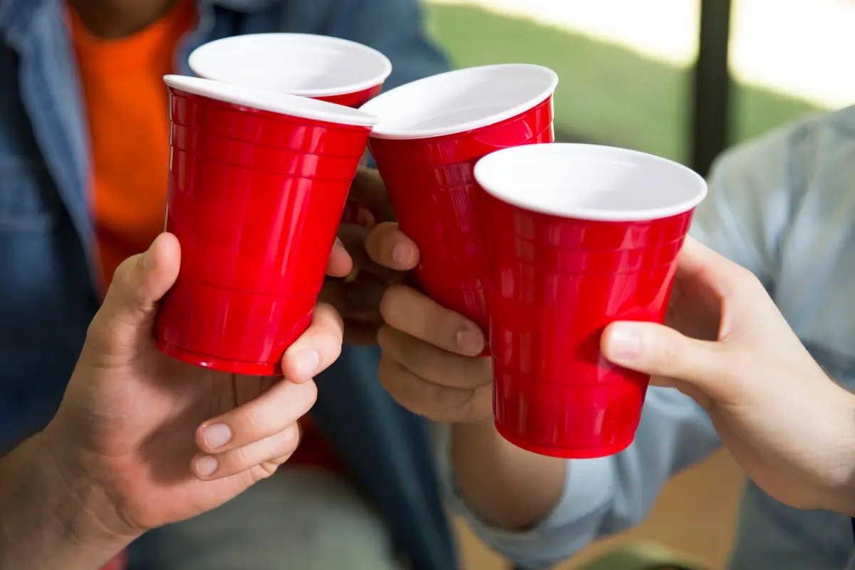 People holding red Solo cups